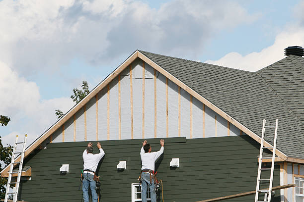 Professional Storm Damage Siding Repair technician working in Houtzdale, PA
